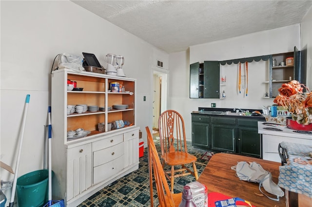 dining space with visible vents and a textured ceiling