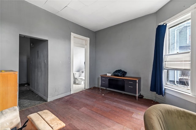 sitting room featuring a healthy amount of sunlight, baseboards, and hardwood / wood-style floors