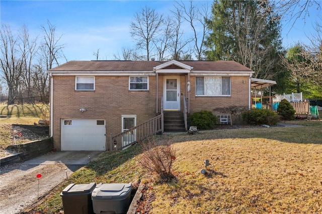 view of front facade with entry steps, concrete driveway, a front yard, an attached garage, and brick siding