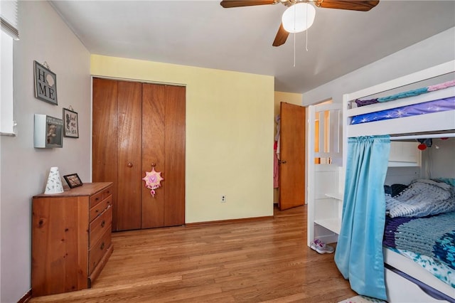 bedroom featuring baseboards, a ceiling fan, and light wood-style floors