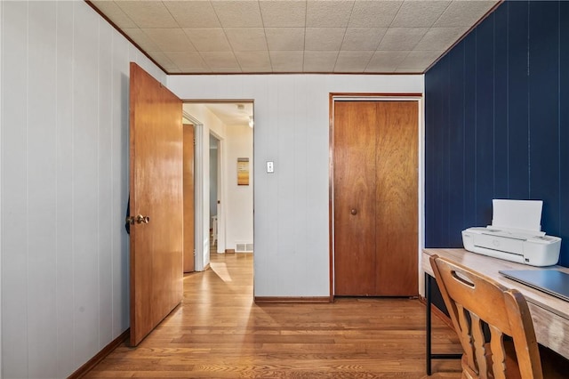 office space with visible vents, baseboards, and wood finished floors