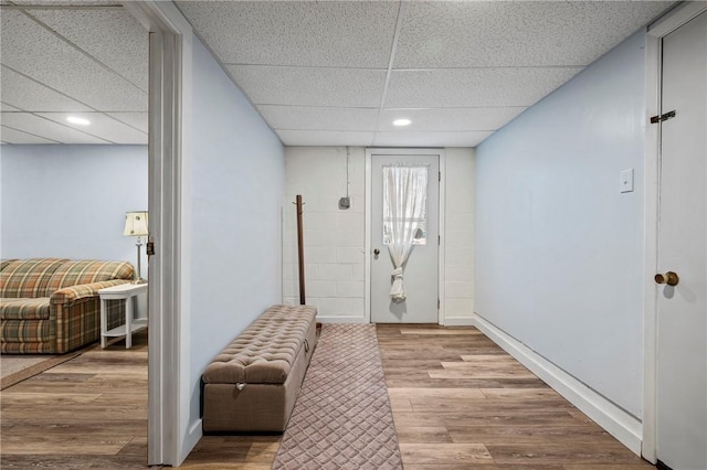 entrance foyer with recessed lighting, wood finished floors, baseboards, and a drop ceiling