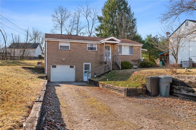 ranch-style home with a garage, brick siding, and driveway