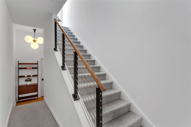 stairway with carpet and baseboards