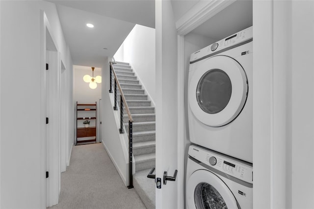 laundry area with laundry area, light carpet, recessed lighting, and stacked washing maching and dryer