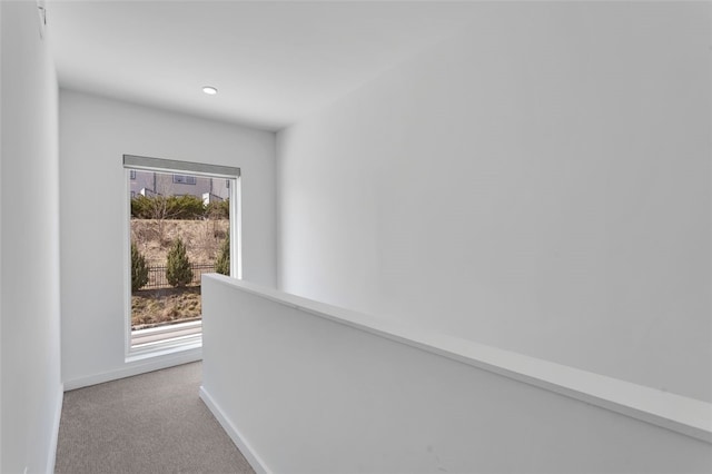 hallway featuring recessed lighting, carpet, and baseboards