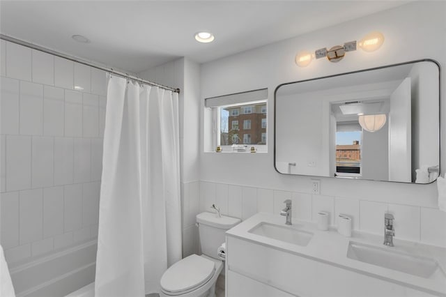 bathroom featuring a sink, toilet, and a healthy amount of sunlight