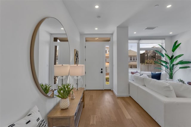 foyer entrance with recessed lighting, light wood-style flooring, and visible vents