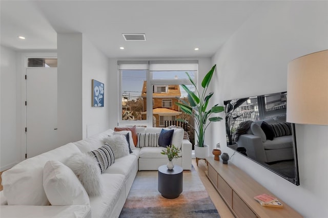 living area with recessed lighting and visible vents