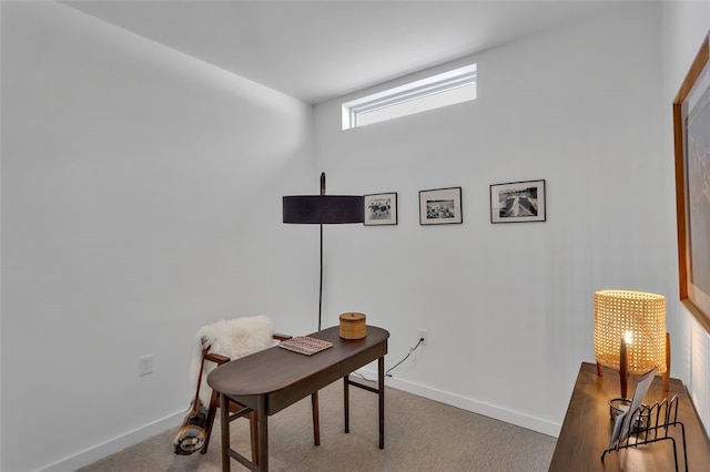 carpeted home office with baseboards