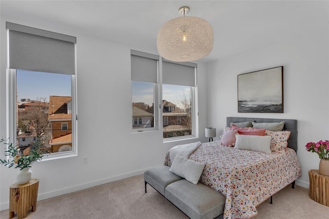 bedroom with baseboards and carpet floors