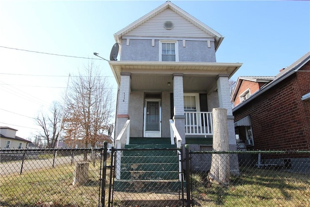 view of front of property featuring a fenced front yard, stucco siding, covered porch, and a gate