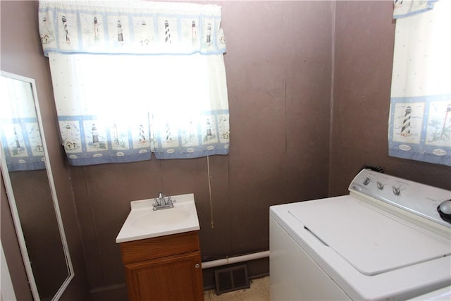 laundry room with visible vents, washer / clothes dryer, laundry area, and a sink