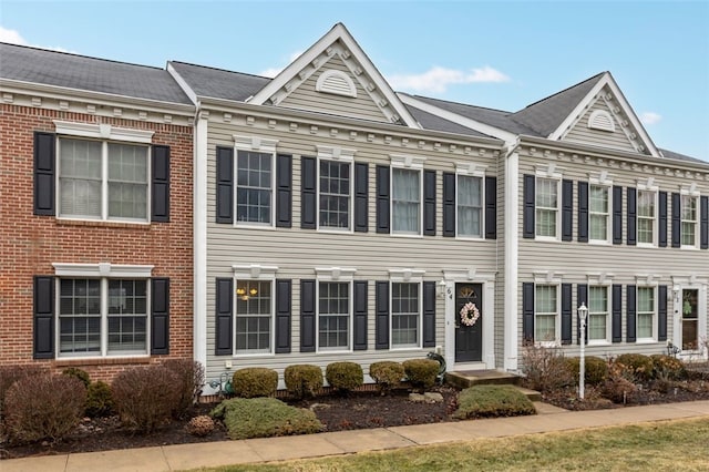 view of property with brick siding