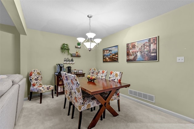 dining area with light carpet, visible vents, baseboards, and an inviting chandelier