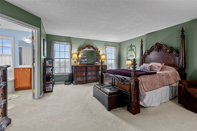 bedroom featuring light carpet, multiple windows, and a textured ceiling