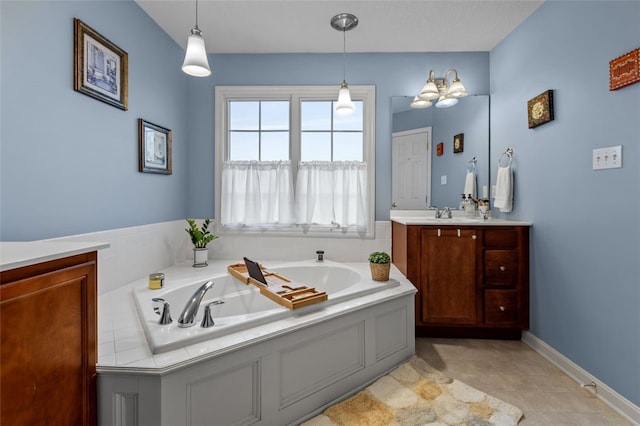 bathroom with baseboards, a garden tub, and vanity