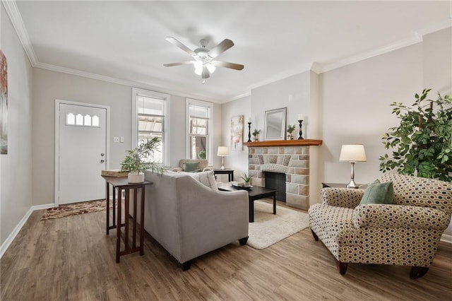 living area featuring ceiling fan, wood finished floors, and ornamental molding