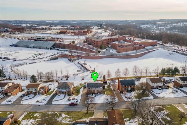 snowy aerial view featuring a residential view