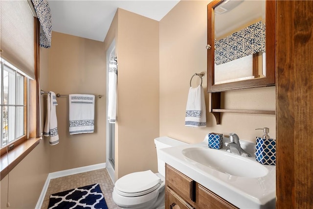 bathroom with a shower with shower door, baseboards, toilet, and vanity