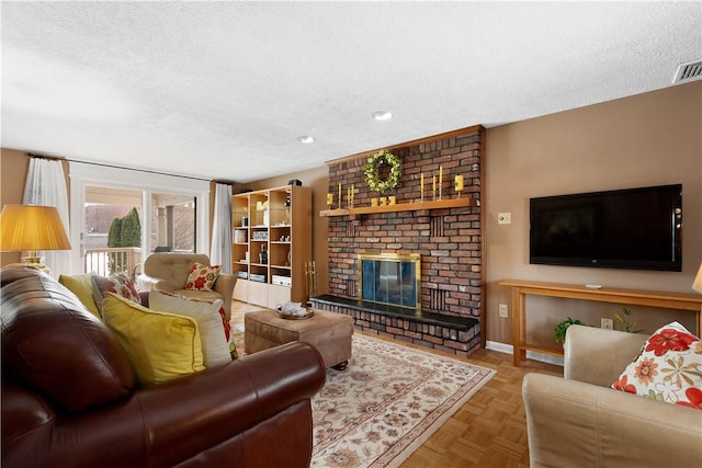 living area with a brick fireplace, a textured ceiling, and baseboards