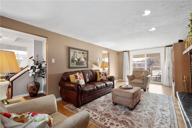 living area featuring baseboards and a textured ceiling