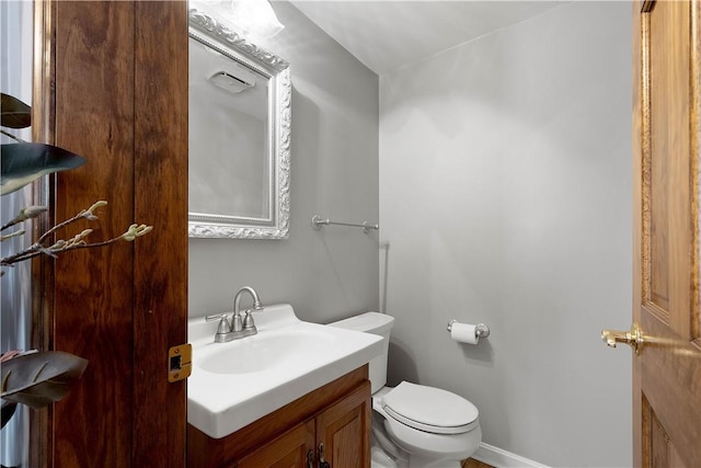 bathroom featuring toilet and vanity