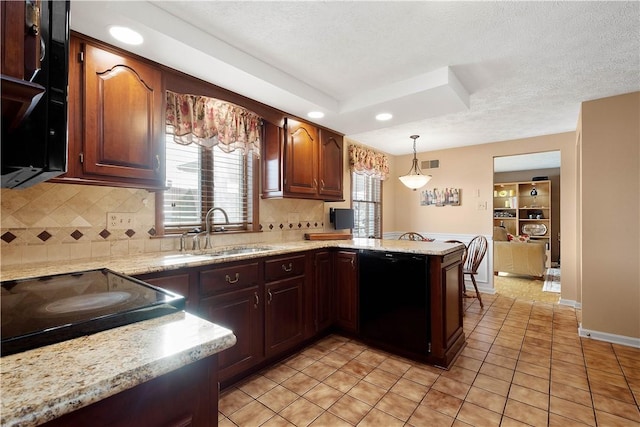 kitchen featuring pendant lighting, a sink, stovetop, a peninsula, and dishwasher