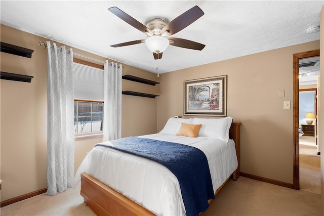 carpeted bedroom featuring baseboards and ceiling fan