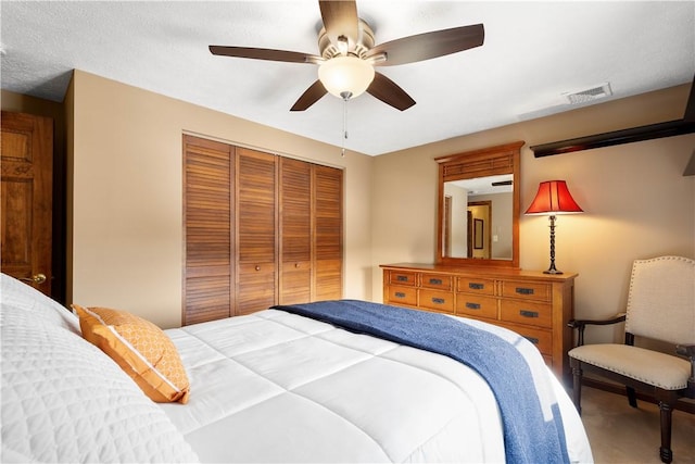 bedroom featuring carpet flooring, visible vents, a closet, and ceiling fan