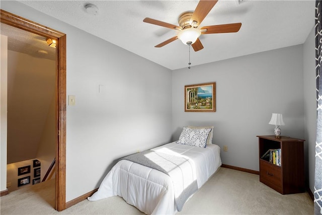 carpeted bedroom with baseboards and a ceiling fan