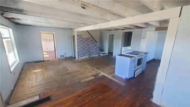 interior space featuring electric range, parquet floors, and visible vents