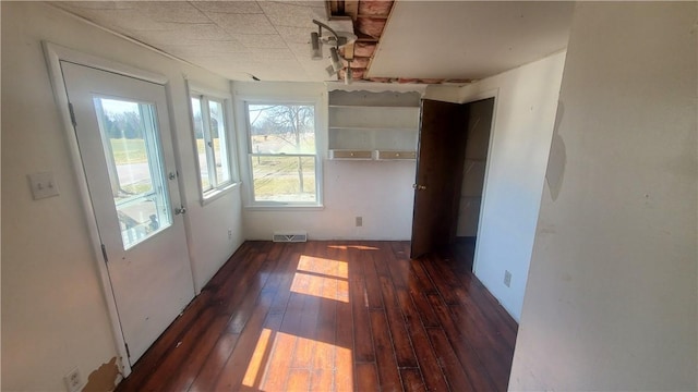 interior space with hardwood / wood-style flooring and visible vents