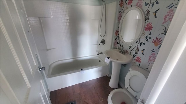 bathroom with shower / tub combination, wood finished floors, and toilet