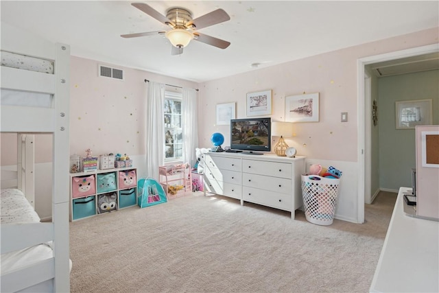 recreation room featuring ceiling fan, attic access, visible vents, and light carpet