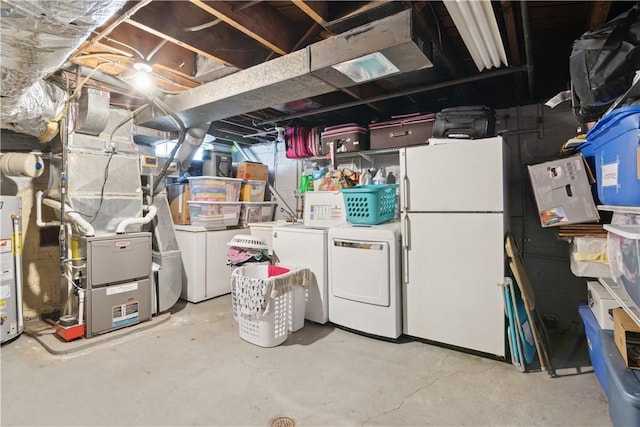 unfinished below grade area featuring gas water heater, heating unit, independent washer and dryer, and freestanding refrigerator