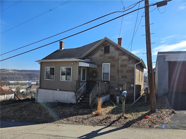 view of front of home featuring a chimney