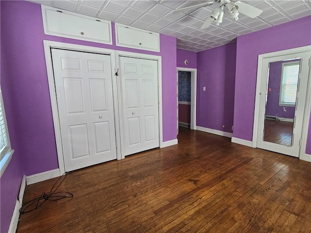 unfurnished bedroom with baseboards, an ornate ceiling, and hardwood / wood-style floors