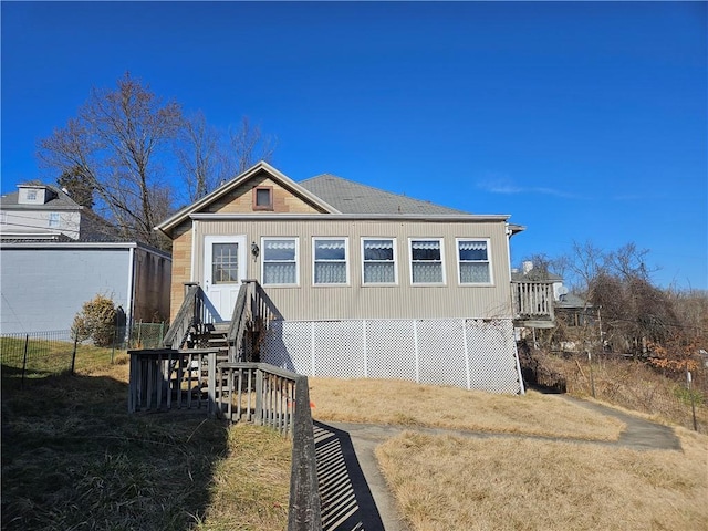 rear view of property with fence