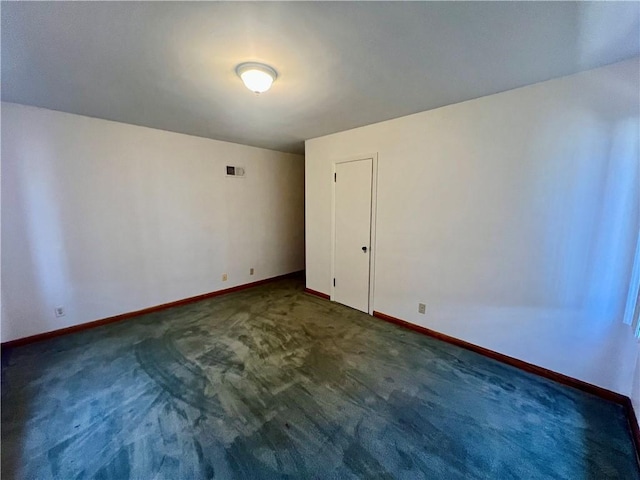 unfurnished room featuring visible vents, baseboards, and carpet flooring