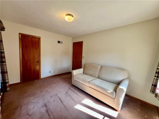 sitting room featuring visible vents, baseboards, and carpet flooring