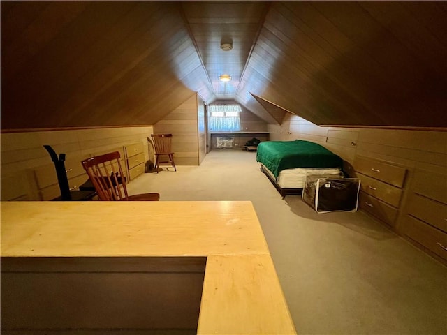 unfurnished bedroom featuring wooden walls, carpet, wooden ceiling, and vaulted ceiling