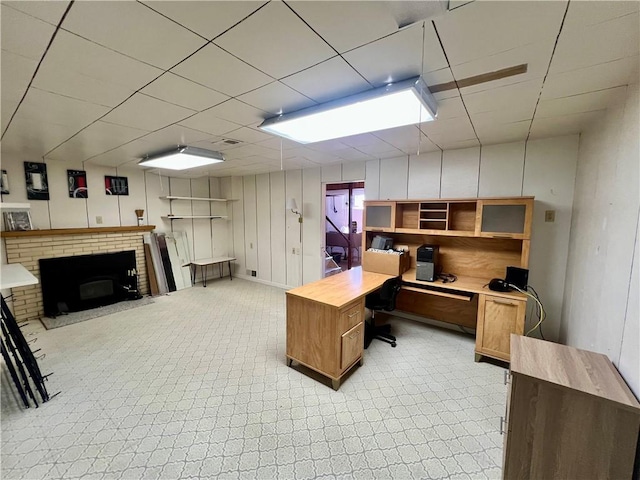 home office featuring a fireplace and a paneled ceiling