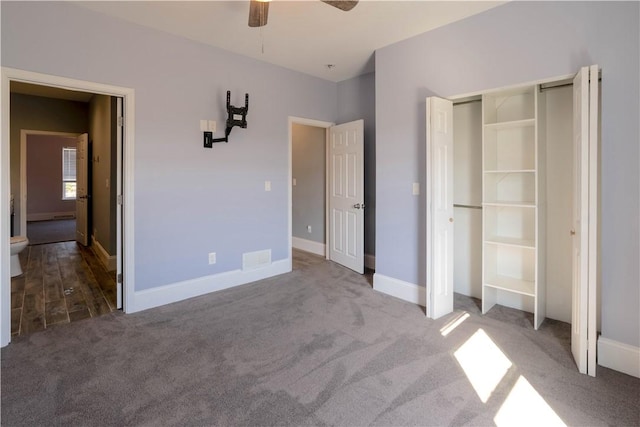 unfurnished bedroom featuring visible vents, a closet, carpet flooring, baseboards, and ceiling fan