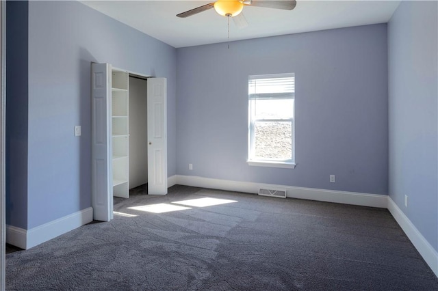 unfurnished bedroom featuring carpet, baseboards, visible vents, and a ceiling fan