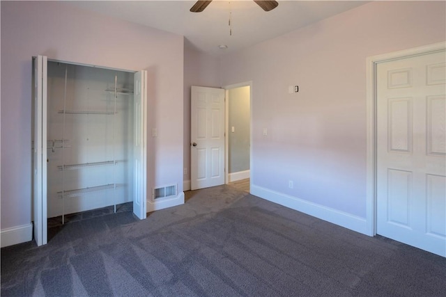 unfurnished bedroom featuring visible vents, a closet, dark colored carpet, baseboards, and ceiling fan