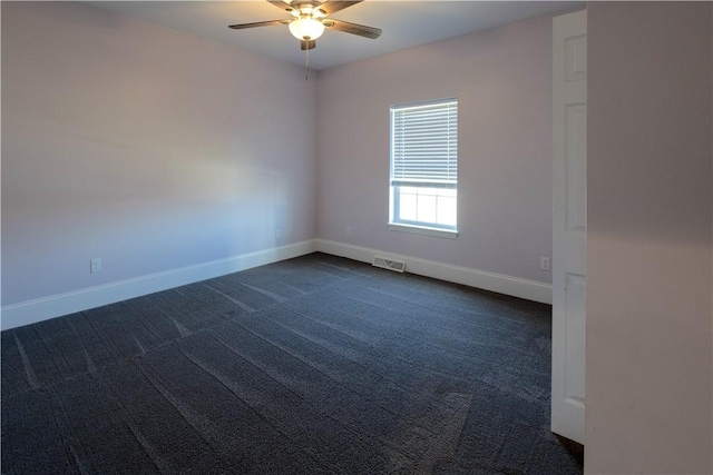 empty room with visible vents, baseboards, dark colored carpet, and ceiling fan