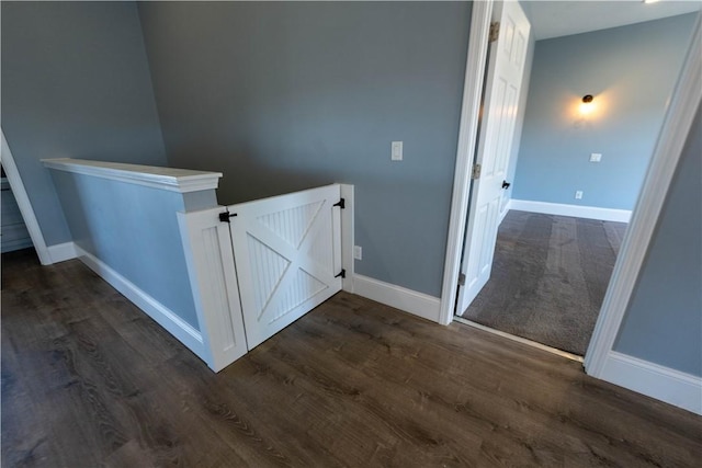 stairway featuring wood finished floors and baseboards