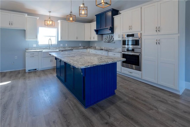 kitchen with white cabinetry, double oven, dark wood-type flooring, and a center island