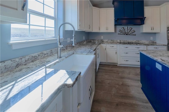 kitchen featuring white cabinetry, black electric stovetop, and light stone counters